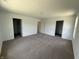 Large bedroom featuring neutral carpet and multiple doors leading to other rooms at 24391 Stout St, Sheridan, IN 46069