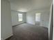 Bright bedroom featuring neutral carpet and a view of the outdoors through a large window at 24391 Stout St, Sheridan, IN 46069