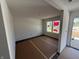 Bright living room with new flooring and large windows, ready for your personal touch at 24391 Stout St, Sheridan, IN 46069