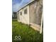 Side view of a boarded up house with siding and lawn at , Indianapolis, IN 46205