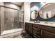 This bathroom features a double vanity, sleek lighting, and a glass-enclosed tiled shower at 2675 Cottage Ct, Brownsburg, IN 46112