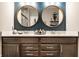Bathroom boasts a stylish double vanity with modern fixtures and round decorative mirrors at 2675 Cottage Ct, Brownsburg, IN 46112