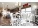 Bright dining area with a round table set for a meal, enhanced by a modern chandelier and natural light at 2675 Cottage Ct, Brownsburg, IN 46112