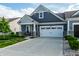 Charming home with a two-car garage, stone accents, and beautifully landscaped front yard at 2675 Cottage Ct, Brownsburg, IN 46112