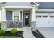 Inviting front porch with stone pillars and cozy seating area, perfect for relaxing and enjoying the outdoors at 2675 Cottage Ct, Brownsburg, IN 46112