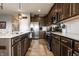 This kitchen showcases stainless steel appliances, sleek countertops, and dark wood cabinetry for a modern appeal at 2675 Cottage Ct, Brownsburg, IN 46112