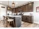 Modern kitchen boasts stainless appliances, dark wood cabinets, a spacious island, and stylish pendant lighting at 2675 Cottage Ct, Brownsburg, IN 46112