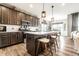 Modern kitchen with stainless steel appliances, a center island with seating, and ample cabinet space at 2675 Cottage Ct, Brownsburg, IN 46112