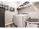 Bright laundry room with modern washer and dryer, shelving, and stylish decor at 2675 Cottage Ct, Brownsburg, IN 46112