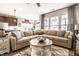 Spacious living room with hardwood floors, stylish furniture, and an open layout connected to the kitchen area at 2675 Cottage Ct, Brownsburg, IN 46112