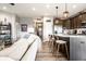 Bright, open-concept living room with a modern kitchen featuring an island and barstool seating at 2675 Cottage Ct, Brownsburg, IN 46112