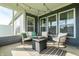 Relaxing screened-in patio with comfortable seating and stylish fire pit on an outdoor rug at 2675 Cottage Ct, Brownsburg, IN 46112