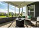 Inviting screened patio with comfortable seating and views of the landscaped backyard at 2675 Cottage Ct, Brownsburg, IN 46112