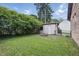 Fenced backyard with detached garage, patio with fire pit and green grass at 309 Poplar Rd, Indianapolis, IN 46219