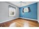Bright bedroom featuring a ceiling fan, hardwood floors, and natural light at 309 Poplar Rd, Indianapolis, IN 46219