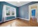 An empty bedroom features hardwood floors and one window at 309 Poplar Rd, Indianapolis, IN 46219
