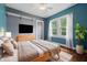 A staged bedroom features hardwood floors and ample natural light at 309 Poplar Rd, Indianapolis, IN 46219