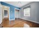 Bedroom features hardwood floors, closet and blue accent wall at 309 Poplar Rd, Indianapolis, IN 46219