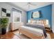 Staged bedroom boasts stylish furniture, hardwood floors, and abundant light at 309 Poplar Rd, Indianapolis, IN 46219