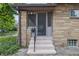 Inviting home entrance featuring brick facade and concrete steps with a black railing at 309 Poplar Rd, Indianapolis, IN 46219