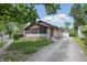 Charming single-story home with a brick facade, detached garage, and well-manicured lawn at 309 Poplar Rd, Indianapolis, IN 46219