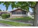 Charming single-story home with a brick facade, a well-kept lawn, and mature shade trees at 309 Poplar Rd, Indianapolis, IN 46219