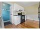 Kitchen featuring black appliances, eat in area, and hardwood floors at 309 Poplar Rd, Indianapolis, IN 46219