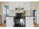 Kitchen featuring white cabinets, modern appliances, and an eat-in area at 309 Poplar Rd, Indianapolis, IN 46219