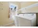 Bright laundry room with a window and washer and dryer hookups at 309 Poplar Rd, Indianapolis, IN 46219