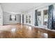 Bright and airy living room featuring hardwood floors, french doors, and ample windows at 309 Poplar Rd, Indianapolis, IN 46219