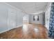 Spacious living room with hardwood floors, arched doorway, and lots of natural light at 309 Poplar Rd, Indianapolis, IN 46219