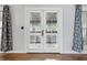 Bright living room with french doors, hardwood floors, and white trim at 309 Poplar Rd, Indianapolis, IN 46219