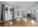Spacious living room with a fireplace, hardwood floors, and natural light at 309 Poplar Rd, Indianapolis, IN 46219