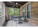 Inviting screened-in porch features a ceiling fan and outdoor dining set at 309 Poplar Rd, Indianapolis, IN 46219