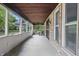 Cozy screened-in porch with brick walls, ceiling fan, and an outdoor dining set at 309 Poplar Rd, Indianapolis, IN 46219