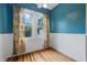 Bright room features hardwood flooring, natural light, and decorative curtains at 309 Poplar Rd, Indianapolis, IN 46219