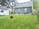 Cozy backyard with a blue home and green grass, perfect for outdoor activities at 310 S Butler Ave, Indianapolis, IN 46219