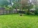 Spacious backyard features well-maintained lawn and a fire pit, perfect for outdoor gatherings at 310 S Butler Ave, Indianapolis, IN 46219