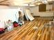 Spacious unfinished basement with durable flooring and plenty of room for storage or customization at 310 S Butler Ave, Indianapolis, IN 46219