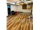 Basement showcasing wood-look flooring and access to laundry area at 310 S Butler Ave, Indianapolis, IN 46219