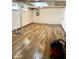 Spacious basement with unique wood grain floors and essential utilities at 310 S Butler Ave, Indianapolis, IN 46219