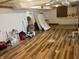 Spacious unfinished basement featuring hardwood-look floors and ample space for storage or recreation at 310 S Butler Ave, Indianapolis, IN 46219