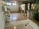 Basement area featuring a tiled and hardwood floor, utility equipment and storage shelves at 310 S Butler Ave, Indianapolis, IN 46219