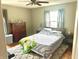 Comfortable bedroom featuring a plush rug, dresser, and queen-sized bed with a quilt at 310 S Butler Ave, Indianapolis, IN 46219