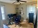 Functional bedroom with hardwood floors, computer desk with dual monitors and exercise equipment at 310 S Butler Ave, Indianapolis, IN 46219