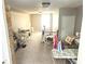 This bonus room has a white table and chairs, ample storage, and natural light from a window at 310 S Butler Ave, Indianapolis, IN 46219