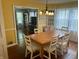 Bright dining room featuring hardwood floors, a chandelier, and a view into the living room at 310 S Butler Ave, Indianapolis, IN 46219