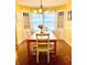Warm dining room with hardwood floors, natural light, and classic chandelier at 310 S Butler Ave, Indianapolis, IN 46219