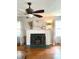 Living room fireplace with mantle, decor, and lots of natural light at 310 S Butler Ave, Indianapolis, IN 46219