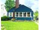 Charming blue two-story home with a brick chimney and well-maintained front lawn at 310 S Butler Ave, Indianapolis, IN 46219